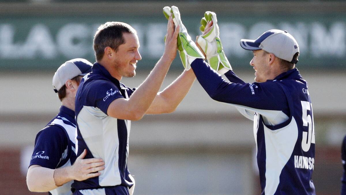 CRUCIAL POLE: Chris Tremain celebrates one his two wickets in Wednesday's win with captain, and final MVP, Pete Handscomb. Photo: AAP/DANIEL POCKETT