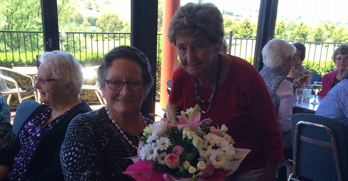 VALUED CONTRIBUTION: Margaret Johnston (right) presenting Helen Chapman (left) with a bouquet of flowers for her volunteer work to Ex-Services Tennis Club. Photo: CONTRIBUTED