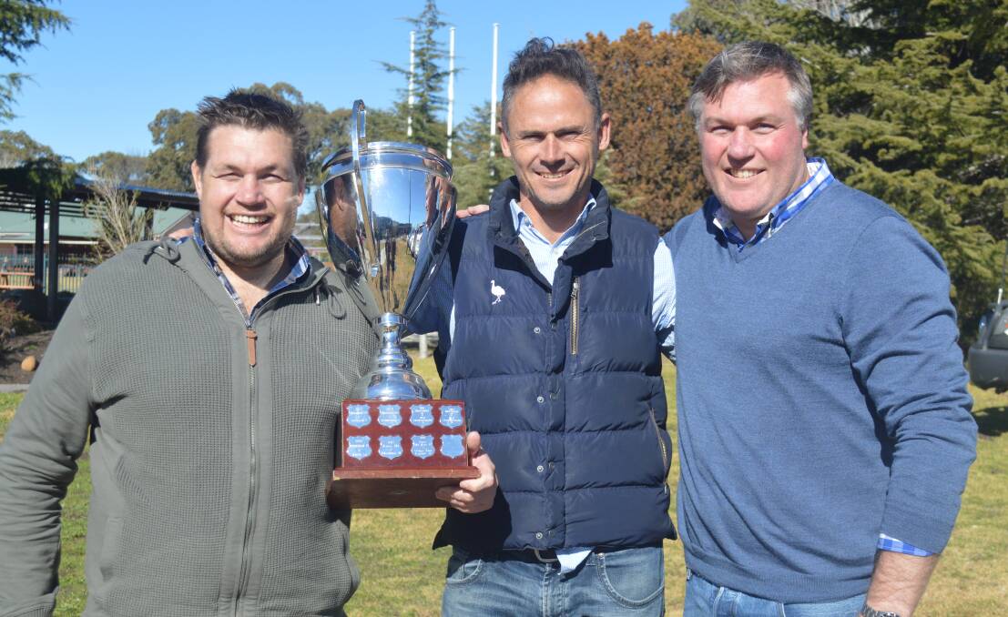 THE SECOND TEST: Bryn and Jason Robertson flank Emus legend Graydon Staniforth, with the Lachlan Robertson Memorial Cup. Photo: MATT FINDLAY