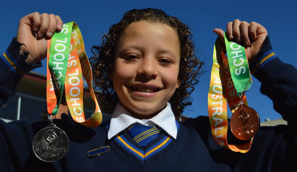 DOUBLE SUCCESS: Orange Public School's Francesca Chitukudza shows off her medals from last month's national championship. Photo: MATT FINDLAY
