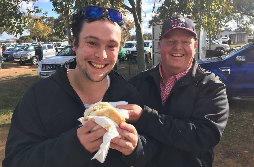 THE CHAMPION: Young Witness editor Pete Guthrie with Cowra Eagles president Ian Robertson, and the now-famous pulled beef sandwich with the lot. Photo: CONTRIBUTED 