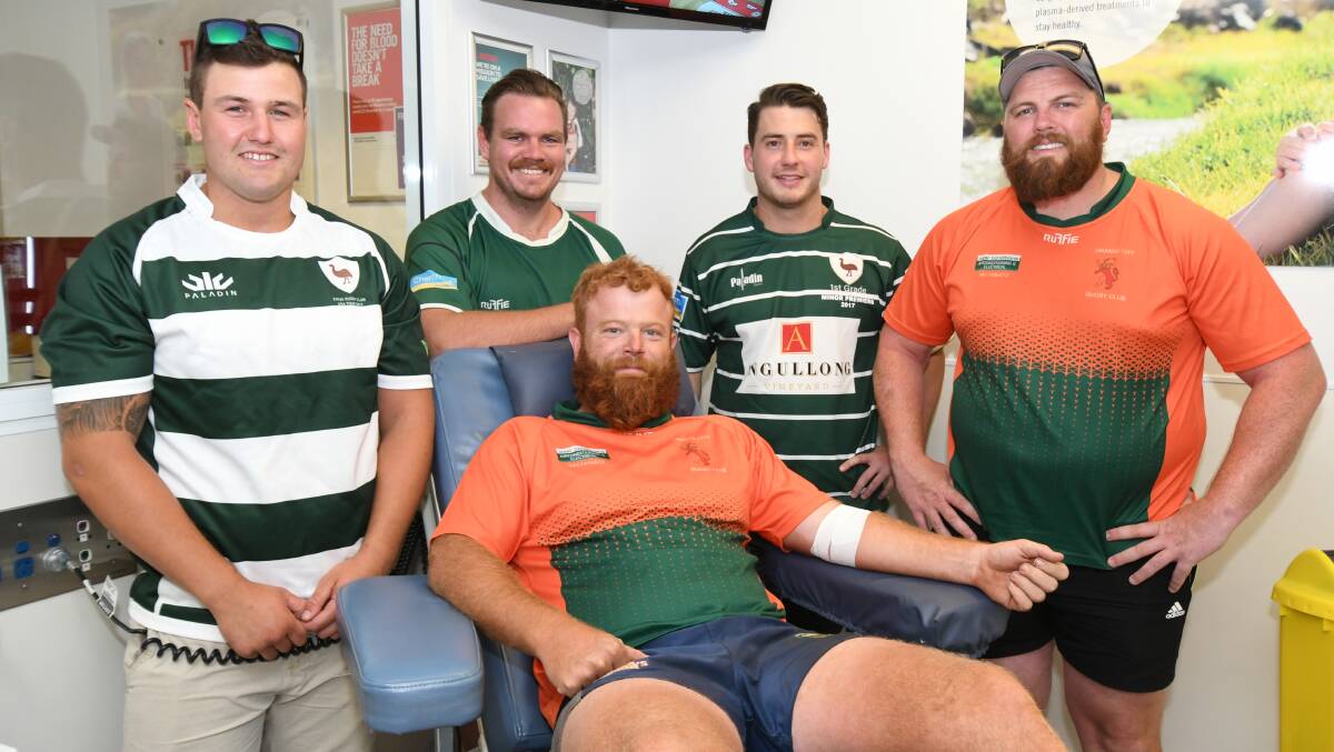 CALL TO ARMS: Orange City club captain Will Ryan donates blood, supported by Emus' Joel Urban, Matt Findlay and Harry Cummins and City's Paul Hepworth. The two clubs send out a call to arms for donors this week. Photo: JUDE KEOGH 1118jkblood1