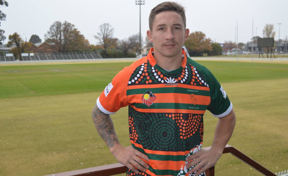 PALPABLE PRIDE: Orange City flanker Jake Johnston shows off his club's Indigenous jersey ahead of this week's local derby, designed by Burruguu Art. Photo: MATT FINDLAY