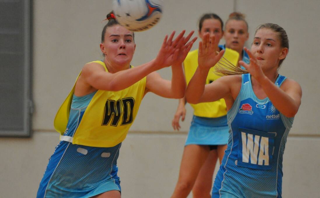 STATE OF PLAY: Life Studio's Alex Emerson in NSW colours at the HeartKids Cup earlier this year, where she marked former Life Studio Annie Miller. Photo: NICK McGRATH