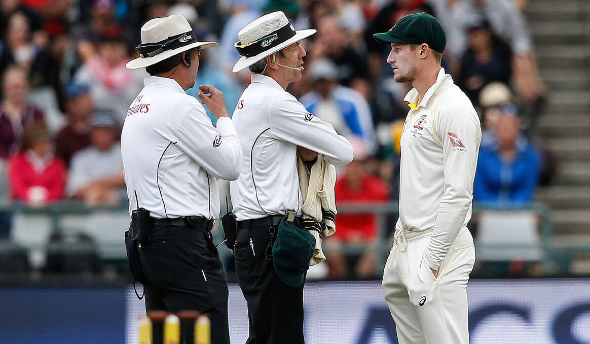 UNDER THE MICROSCOPE: Cameron Bancroft is questioned by umpires in South Africa, after tampering with the ball in the third Test. Photo: GIANLUIGI GUERCIA