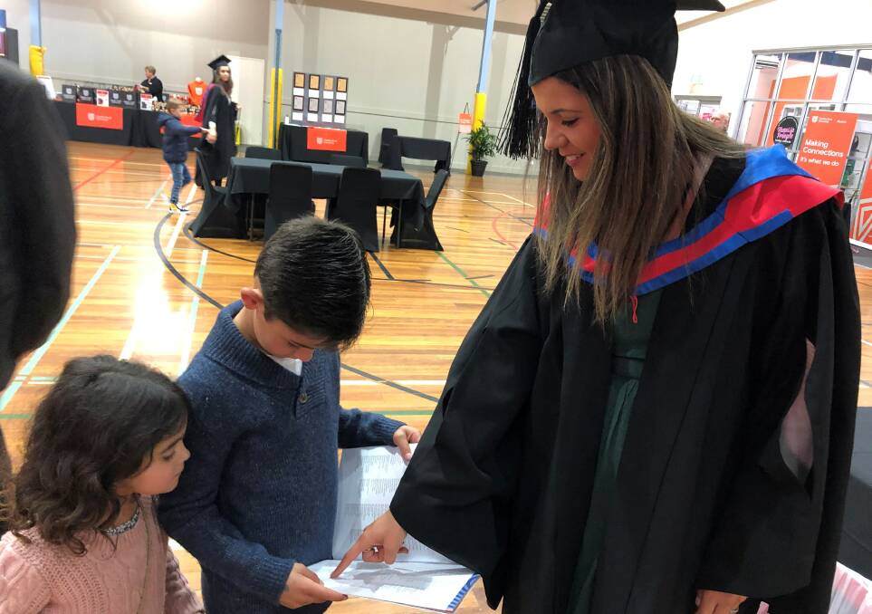 FAMILY AFFAIR: Charles Sturt graduate Jenna Hattersley was stoked to have her kids (from left) Tilly and Angus on hand to help her mark the occasion. Photo: CHARLES STURT MEDIA