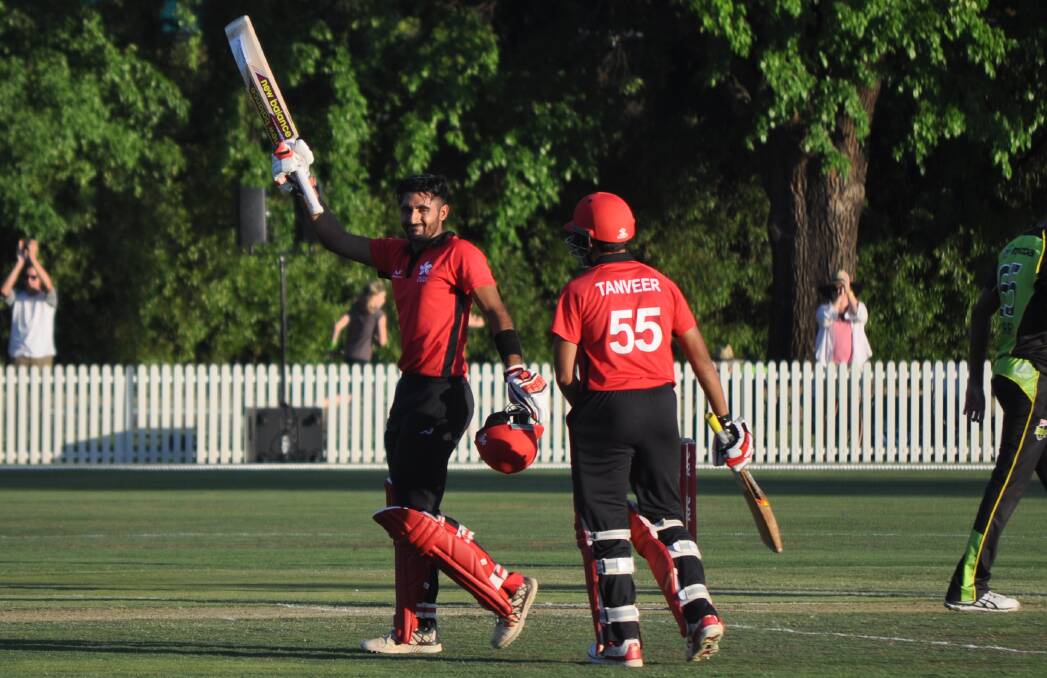 WHAT A MOMENT: Nizakat Khan salutes the crowd after bringing up his ton at Wade Park on Sunday afternoon. Photo: NICK McGRATH