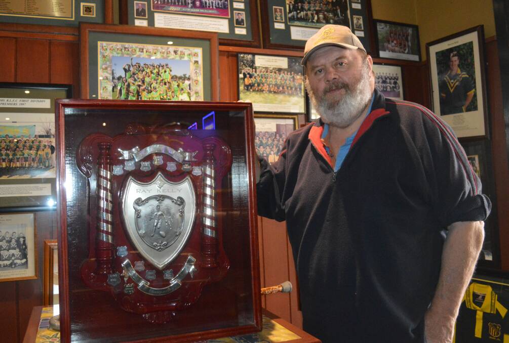 BACK HOME: Phil Kelly shows off the recovered Ray Kelly Memorial Shield, named after his older brother and once again up for grabs in Sunday's derby. Photo: MATT FINDLAY