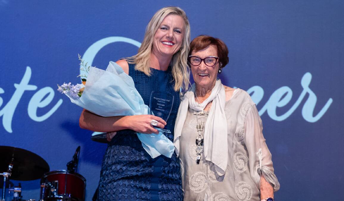SPECIAL: Mardi Aplin receives Netball NSW's coach of the year gong from the award's namesake, Margaret Corbett OAM. Photo: NICOLE SPANGHER