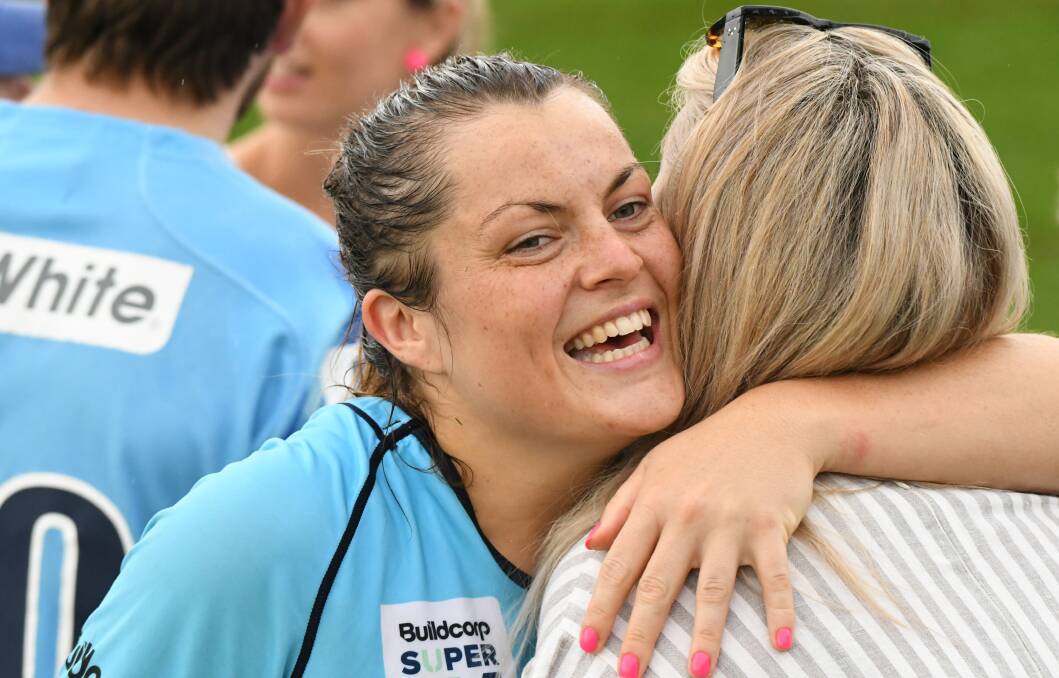 DECIDER DREAMS: Grace Hamilton hugs a family member following the Waratahs' win in Bathurst, she'll line up at No.8 in Sunday's grand final. Photo: CHRIS SEABROOK