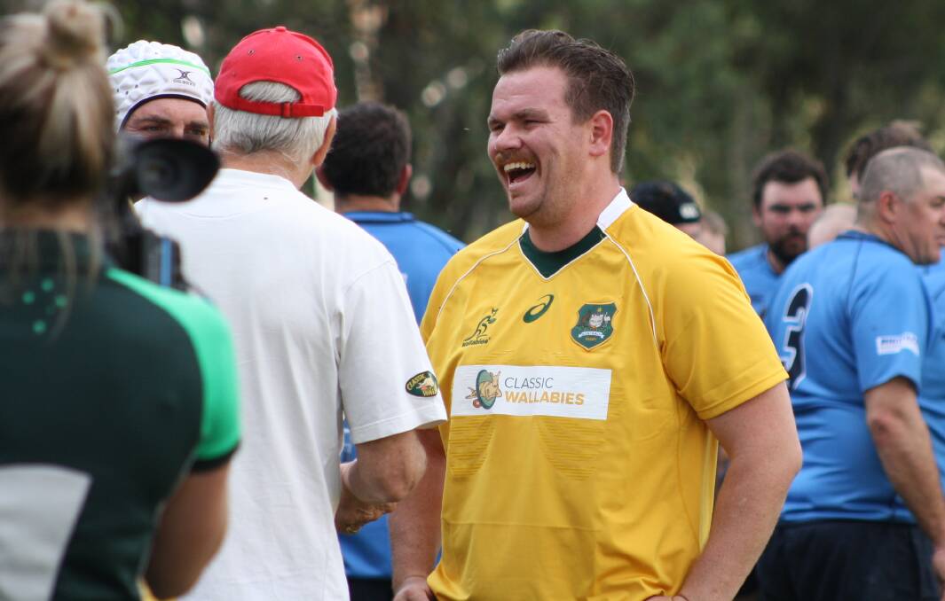 A TRUE WANNABE: Matt Findlay has a laugh on Endeavour Oval's sideline with Classic Wallabies coach Gary Pearse (red cap). Photo: MICHELLE COOK