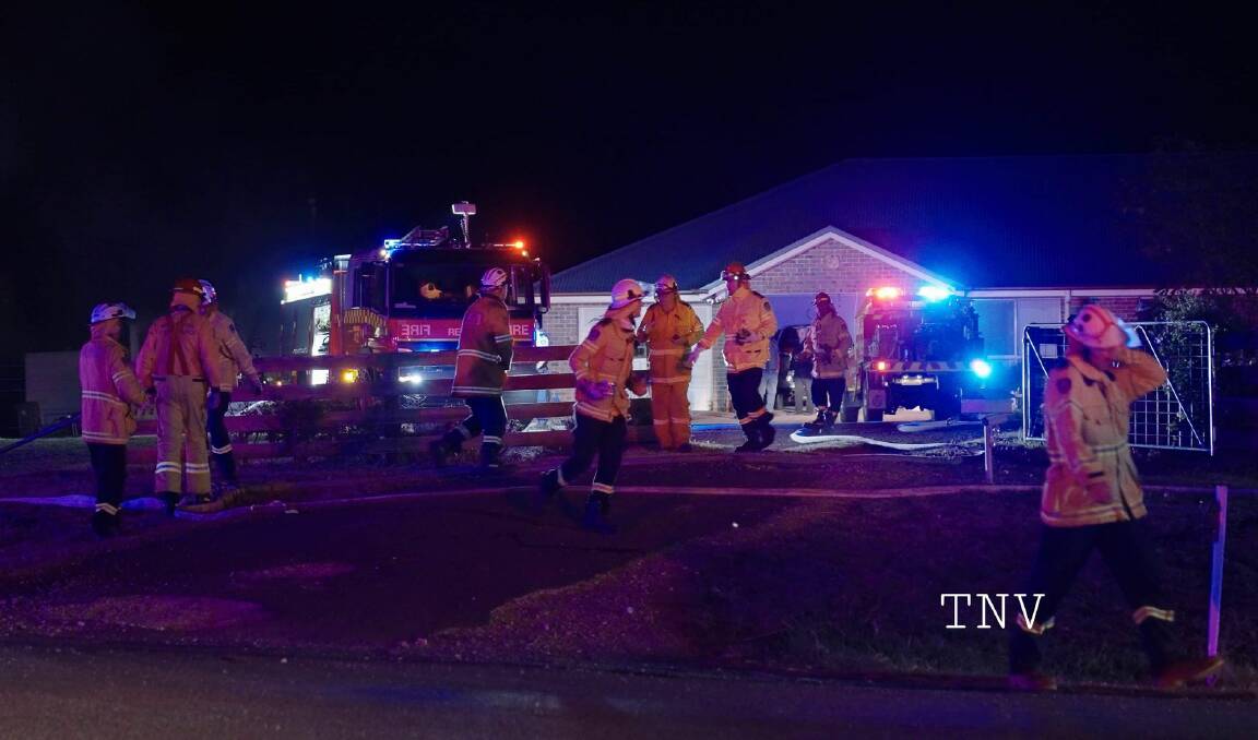 BLAZE: Fire crews work to extinguish a shed fire at Clifton Grove on Wednesday night. Photo: TOP NOTCH VIDEO/TROY PEARSON