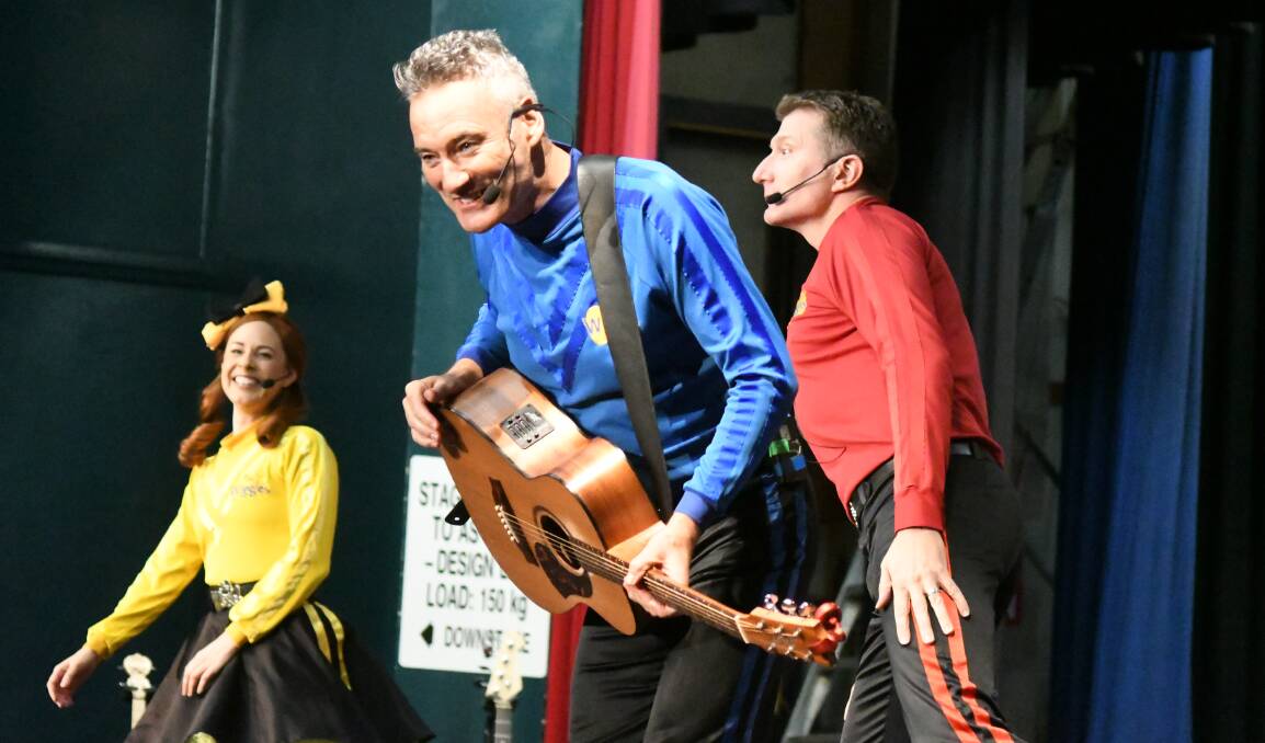 POTPONED: Blue Wiggle Anthony Field (front), flanked by Emma Watkins and Simon Pryce playing in Orange in 2018. The band has been forced to reschedule their Central West tour dates. Photo: JUDE KEOGH
