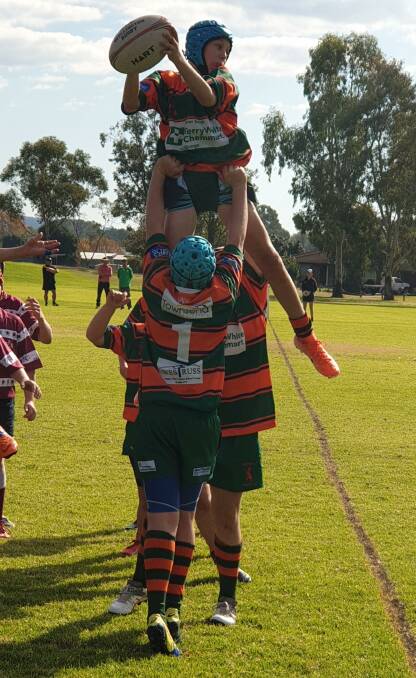 FLYING HIGH: Orange City's James Walker springs up to win a lineout, lifted by Alex O'Brien (No.1), in the Lions' under-13 victory over Wellington on Saturday. Photo: DEE O'BRIEN