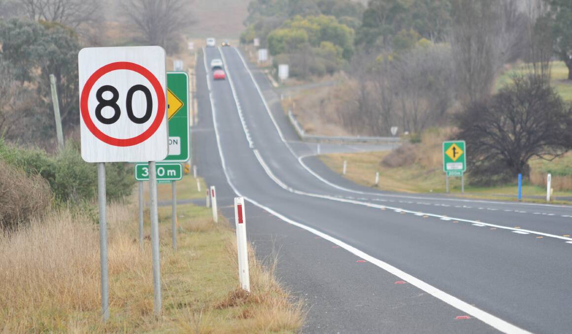 REDUCED: New speed limit signs at the Thompson Road intersection on the Mitchell Highway were established on Monday. Photo: JUDE KEOGH