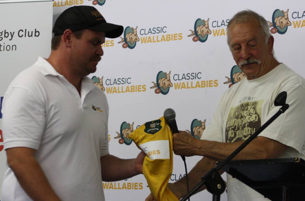 JERSEY PRESENTATION: Matt Findlay sheepishly accepts his first, and definitely only, Wallabies jersey from Classics coach Gary Pearse. Photo: MICHELLE COOK