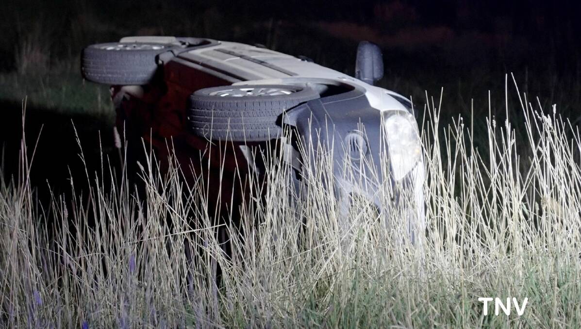 ACCIDENT: A car rolled on the Mitchell Highway on Tuesday night, a woman and two children escaped with only minor injuries. Photo: TOP NOTCH VIDEO/TROY PEARSON