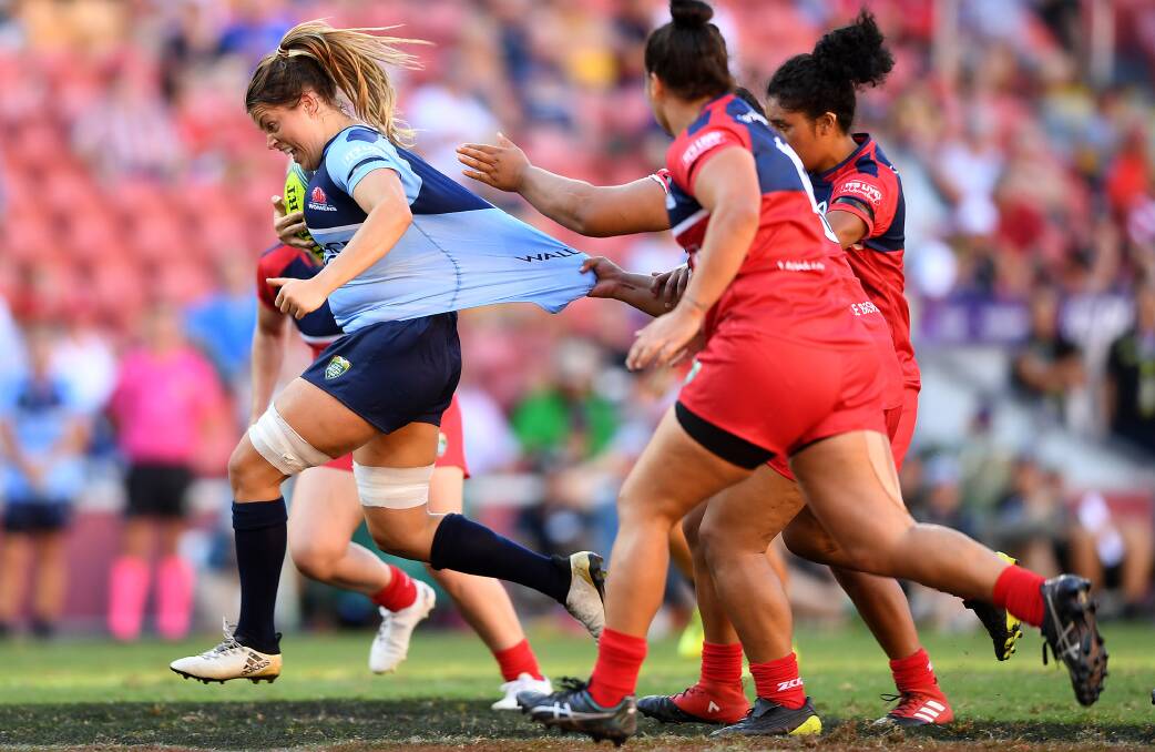THE BLINDSIDE: Grace Hamilton, pictured making a line-break at the Brisbane Global Rugby Tens, will start in NSW's No.6 jersey in this weekend's landmark first round. Photo: AAP/DAVE HUNT