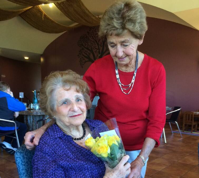 VALUED MEMBER: Life member Margaret Johnston (right) presenting roses to club Patron and life member Dolly Kjoller, for her longtime dedication to our club. Photo: CONTRIBUTED