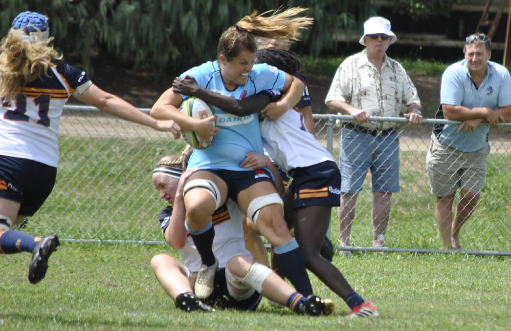 POWERHOUSE: Panuara's Grace Hamilton proves tough to bring down in her Waratahs' trial win over the Brumbies on Satureday. Photo: SOUTHERN HIGHLAND NEWS
