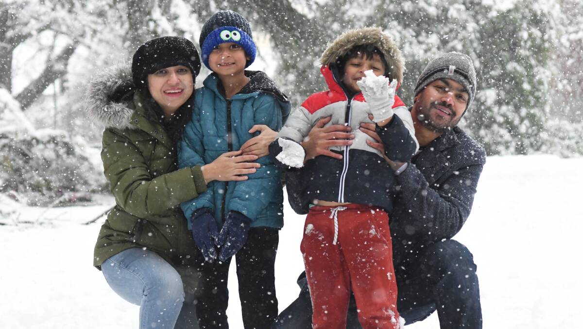 LET IT SNOW: Tazeen Ansari, Zayan, Kamran and Hamdaan Ahmed are all smiles during last week's dumping of snow in Orange. Photo: JUDE KEOGHJ