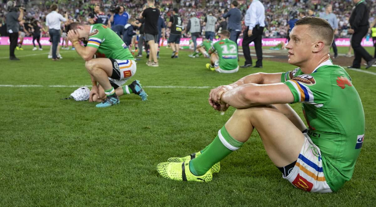 AGONY: Jack Wighton (foreground) and Jarrod Croker slump to the ANZ Stadium turf after full-time in Sunday's grand final loss. Photo: SITTHIXAY DITTHAVONG

