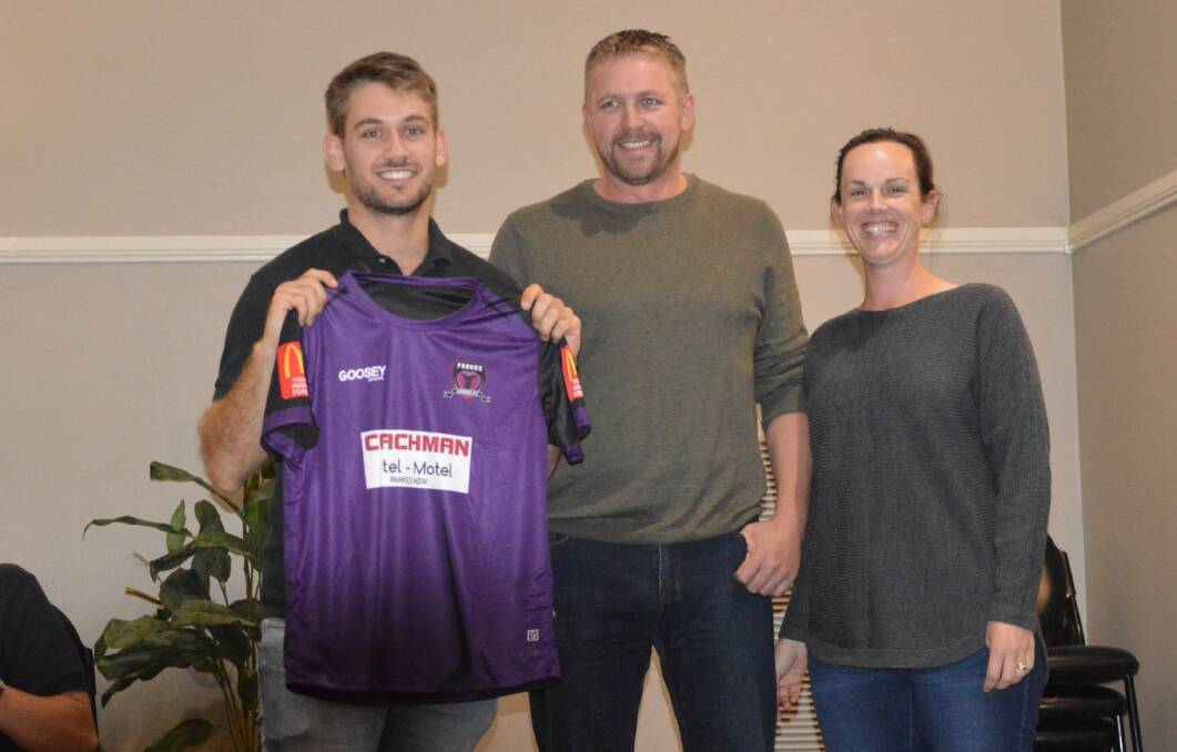 PURPLE PEOPLE EATER: Cobras' ace Hayden Westcott shows off Parkes' new kit, after being presented it by Michelle and Richard Bligh from Choices Flooring. Photo: CONTRIBUTED