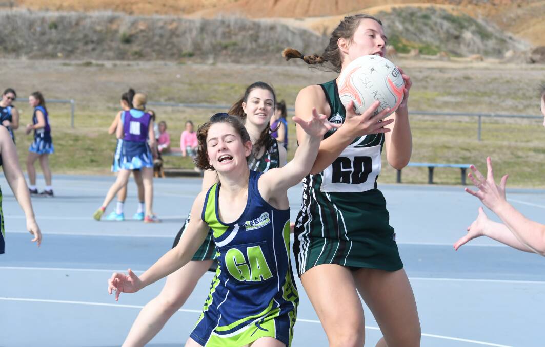 RACE IS ON: Life Studio Warriors' Laura Turner battles for possession with CSU Aggies' Hannah Wallace earlier this season. Both their sides are chasing division three leaders Hawks Terry White Chemist. Photo: JUDE KEOGH