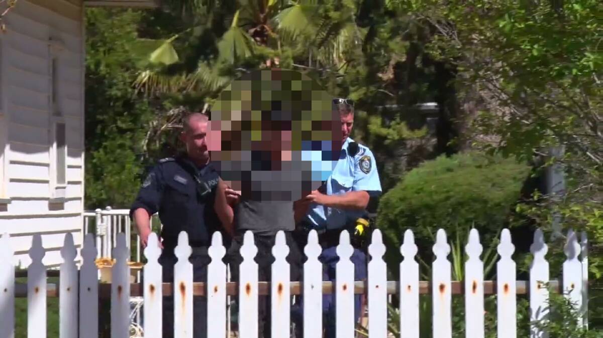 INVESTIGATION: Officers arrest a man in Canowindra this morning. Photo: TROY PEARSON/Top Notch Video