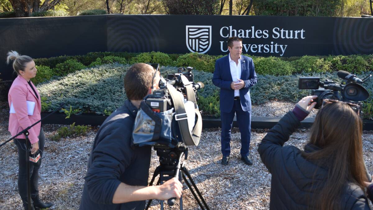 QUESTION TIME: Bathurst MP Paul Tool fronts the local media at the entrance to the Bathurst campus of Charles Sturt University.