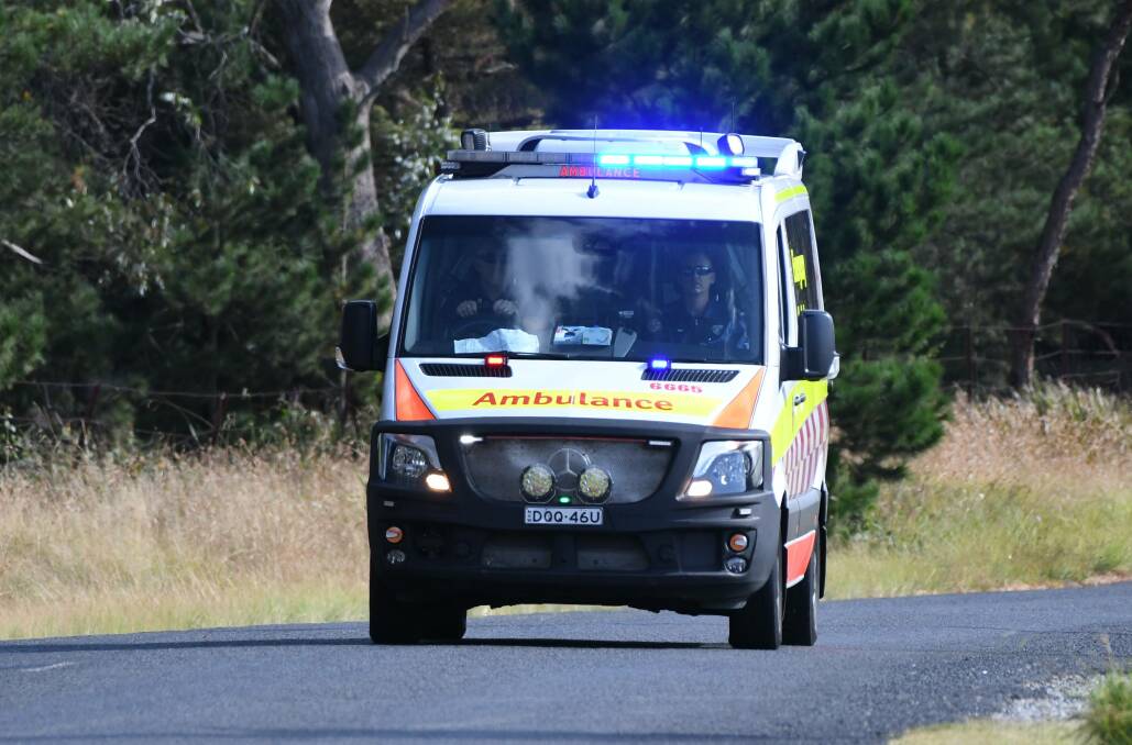 An ambulance rushes to the scene of yesterday's crash. Photo: CHRIS SEABROOK