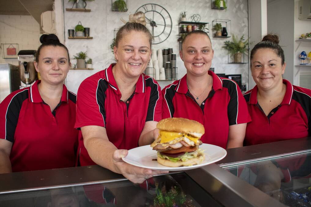 Mouth-watering: Rachel Campbell, co-owner Annette Burge, Kristy Coy and Nioka Wilson of Burgie's Burger Bar in Dubbo, with one of their award-winning burgers. Photo: BELINDA SOOLE