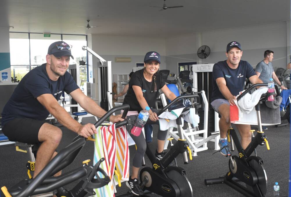 SPINNING FOR SPINAL: Harry Fardell, Jenna Hattersley and Andrew Swain at the 24-hour ride at Integra Gym. Photo: JUDE KEOGH