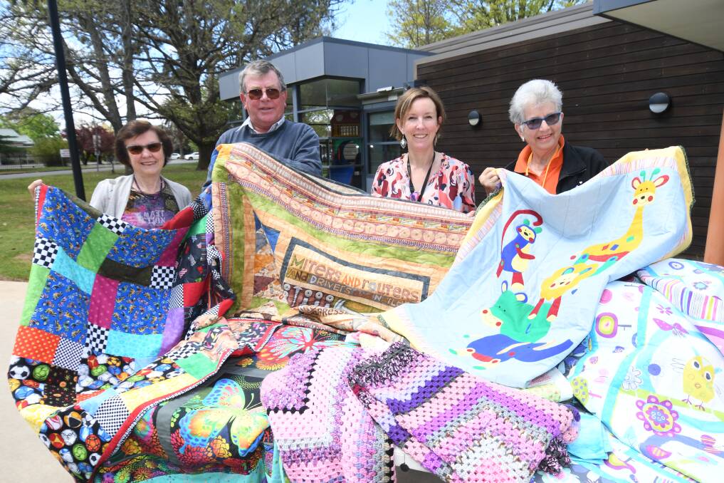 COLOURFUL DONATION: Lindy and John Randall, CEO of RMH Rebecca Walsh and RMH volunteer Judy Reppen. Photo: JUDE KEOGH.