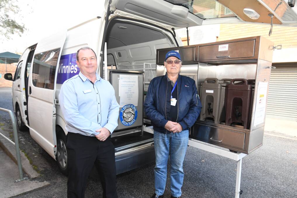 HELPING HAND: Vinnies Regional Director Phil Donnan and volunteer Graeme Press with the Vinnies Van, which provides food for locals doing it tough. PHOTO: JUDE KEOGH