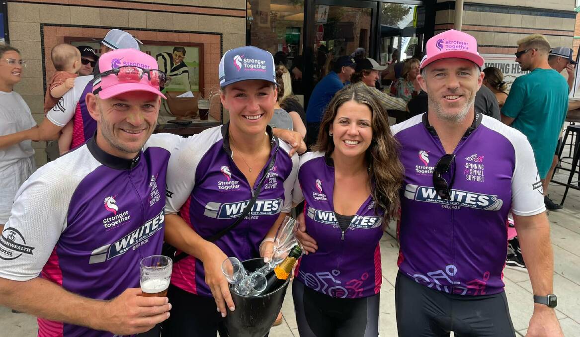 MADE IT: Cyclists Harry and Sophie Fardell and Jenna and Al Hattersley celebrate in Newcastle after completing their ride from Orange. Photo: SUPPLIED