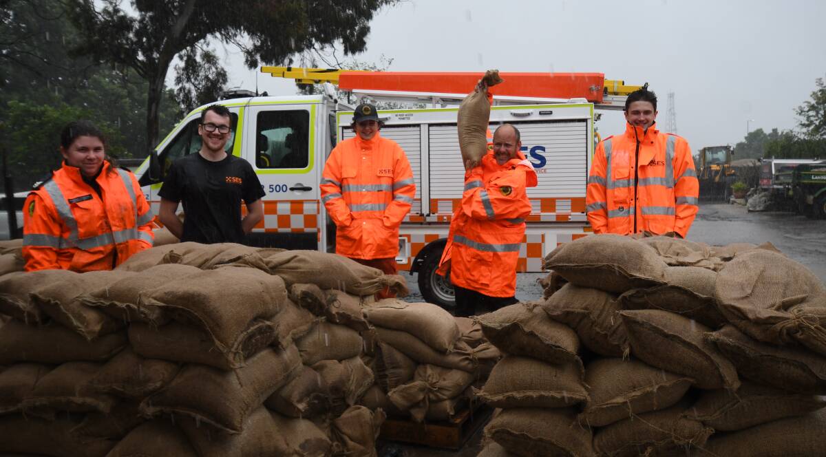 IN THE BAG: Orange SES Volunteers Kimberley Cashman, Michael Ryan-Everett, Luke Stevens, Michael Hughes and William Guthrie have been helping fill sandbags to be trucked out to flood affected areas. Photo: Carla Freedman