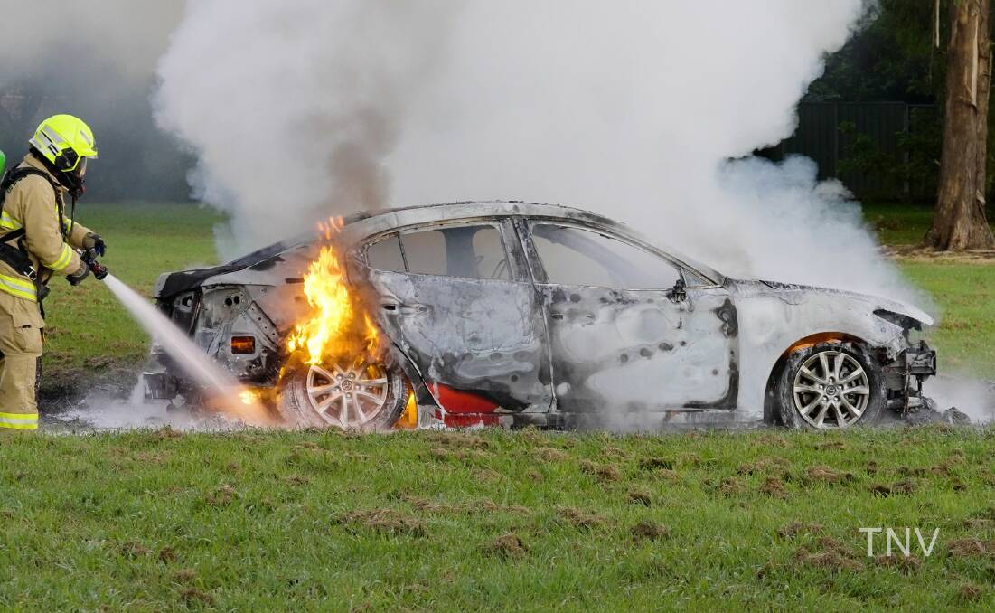 DESTROYED: The red Mazda set on fire after a police pursuit on Tuesday morning. Photo: TROY PEARSON