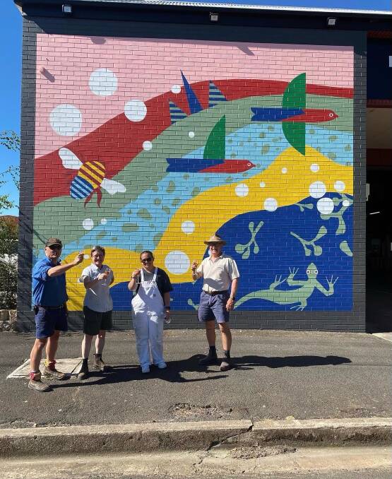 NATURAL BEAUTY: Justin and Pip Jarrett of SeeSaw Wines, sign writer Alicia McDonell and Len Banks in front the mural at the Carriers Arms bottleshop.