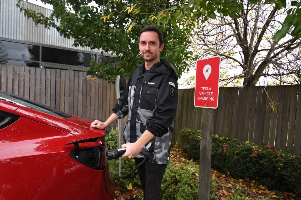 PLUGGING IN: Jesse Badger and his Tesla Model 3 Performance at Heifer Station's Tesla chargers. Photo: CARLA FREDMAN