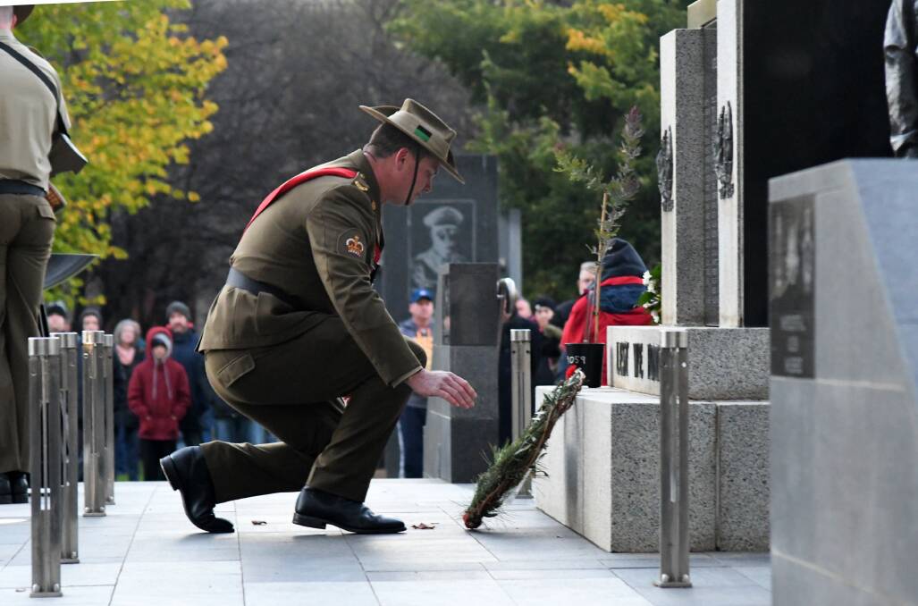 REMEMBERING THE FALLEN: A soldier lays a wreath at the cenotaph in Robertson Park during Anzac Day 2021 commemorations. Photo: CARLA FREEDMAN