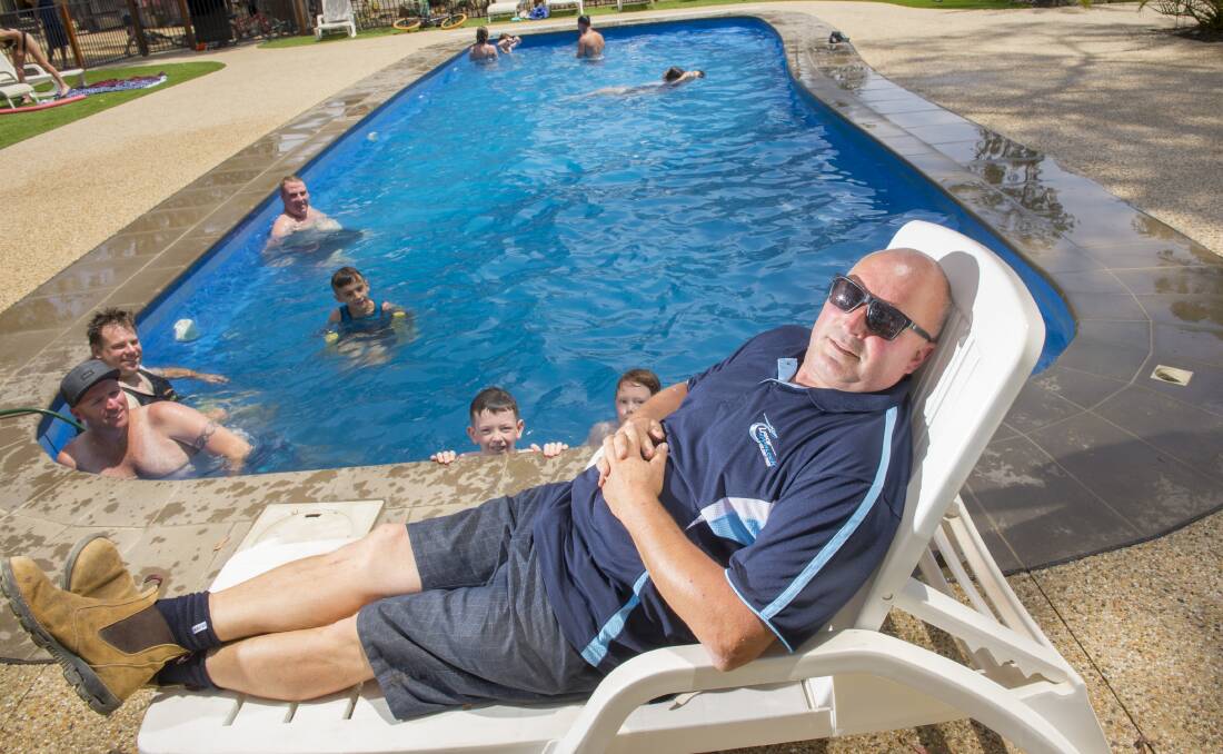 Rare rest: Lake Eppalock Holiday Park owner and operator Peter Rose gets a rare moment's rest by the pool during the summer school holiday peak. PIcture: DARREN HOWE