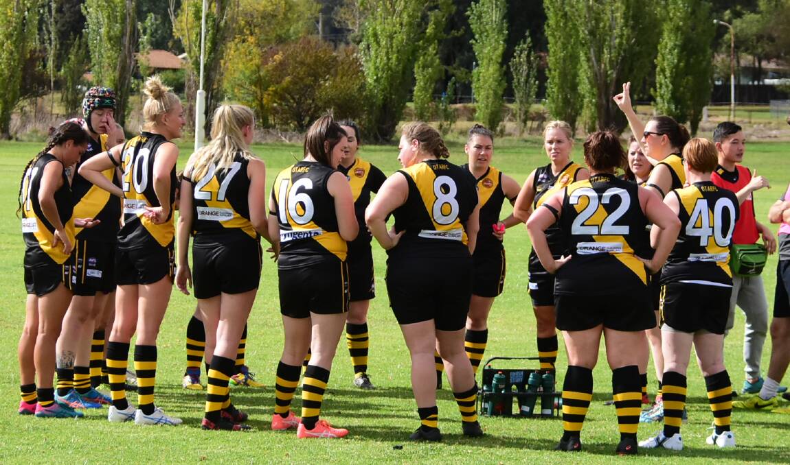 IN CHARGE: The Tigers being addressed by coach Nita Noble in the quarter-time huddle of their first game against Cowra. Photo: BEN RODIN.