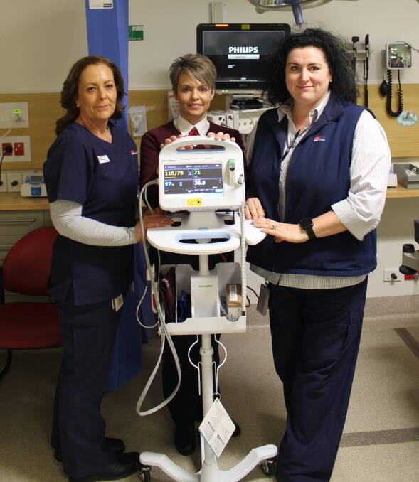 HAPPY: Cathy Whiteman, Rochelle Ashcroft and Mim Eaton with a monitor. 