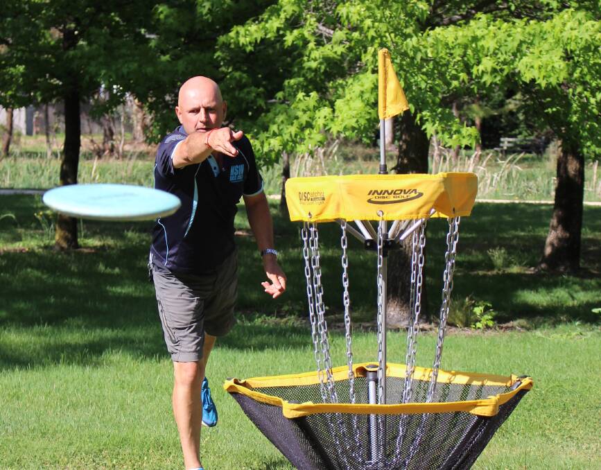 LET IT RIP: Kevin Costa shoots at a disc-golf net last year. He'll be setting up at Molong Golf Course next month. Photo: MAX STAINKAMPH