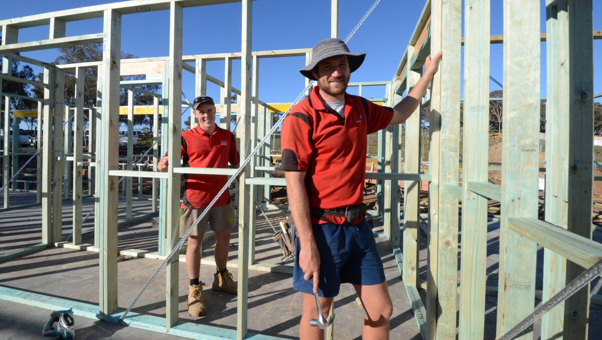 BUILDING BOOM: Pat Williams and Andrew Cummins putting up frames for a house in north Orange on Thursday. Photo: JUDE KEOGH