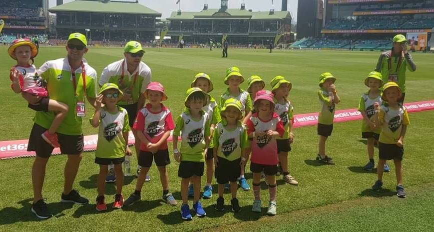 SMILES FROM EAR TO EAR: Orange's youngest cricketers lining up before walking onto the field at the SCG. Photo: SUPPLIED. 