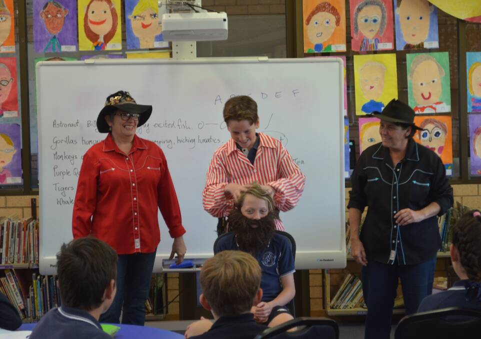 Melanie Hall, Logan Whiteley (in red and white), a bearded Xavier Bland and Suzie Carcary act out Banjo Paterson's 'The Man from Ironbark'. Photo: MAX STAINKAMPH 1019MSpoetry1