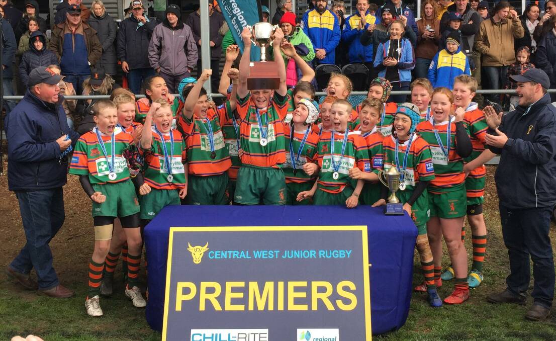 PREMIERS: Orange City's under-13 side celebrates their grand final win, with player of the match Harry Kukla raising the trophy. Photo: MAX STAINKAMPH