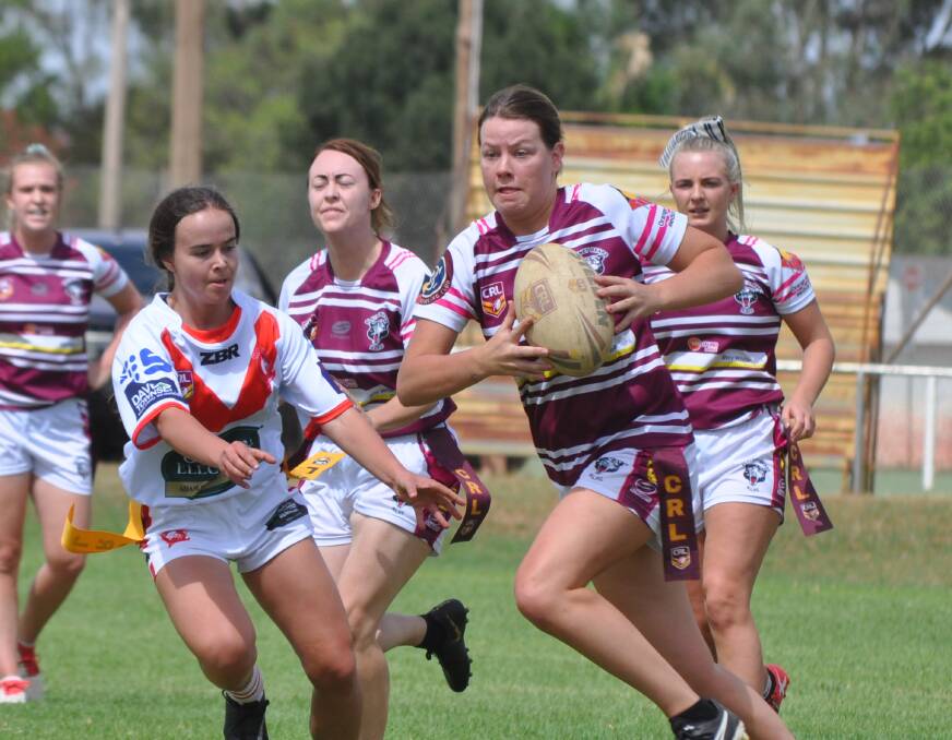 Blayney's Grace mooney escapes a tag from Manildra' Sarah Kirkness